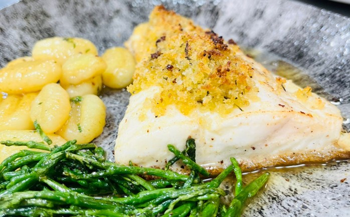 Close up of Halibut fillet, pan-fried gnocchi and British samphire.